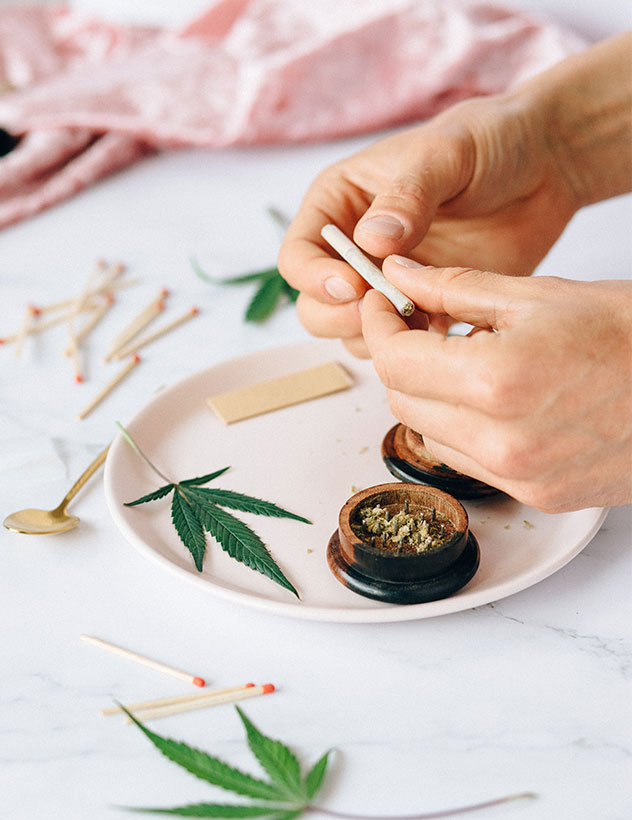 Person Rolling Cannabis